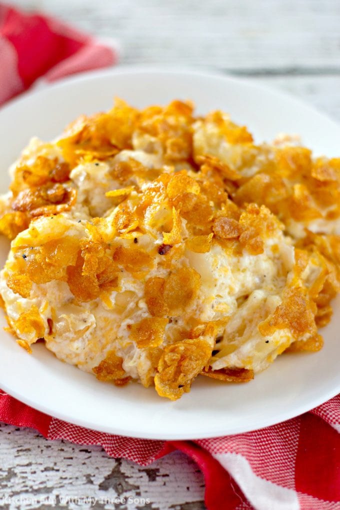 Easy Funeral Potatoes Recipe on a white plate with a red napkin
