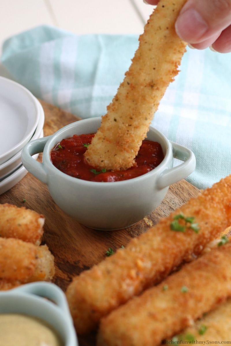 dipping fried cheese in sauce