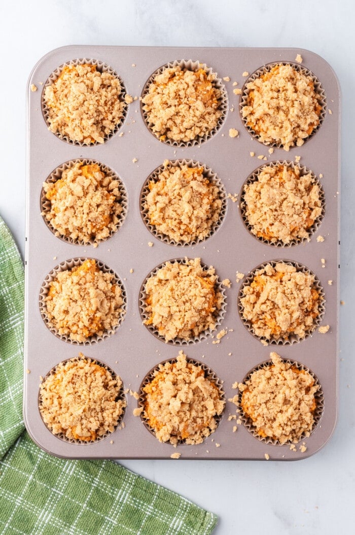 Pumpkin muffins with streusel topping in a muffin pan