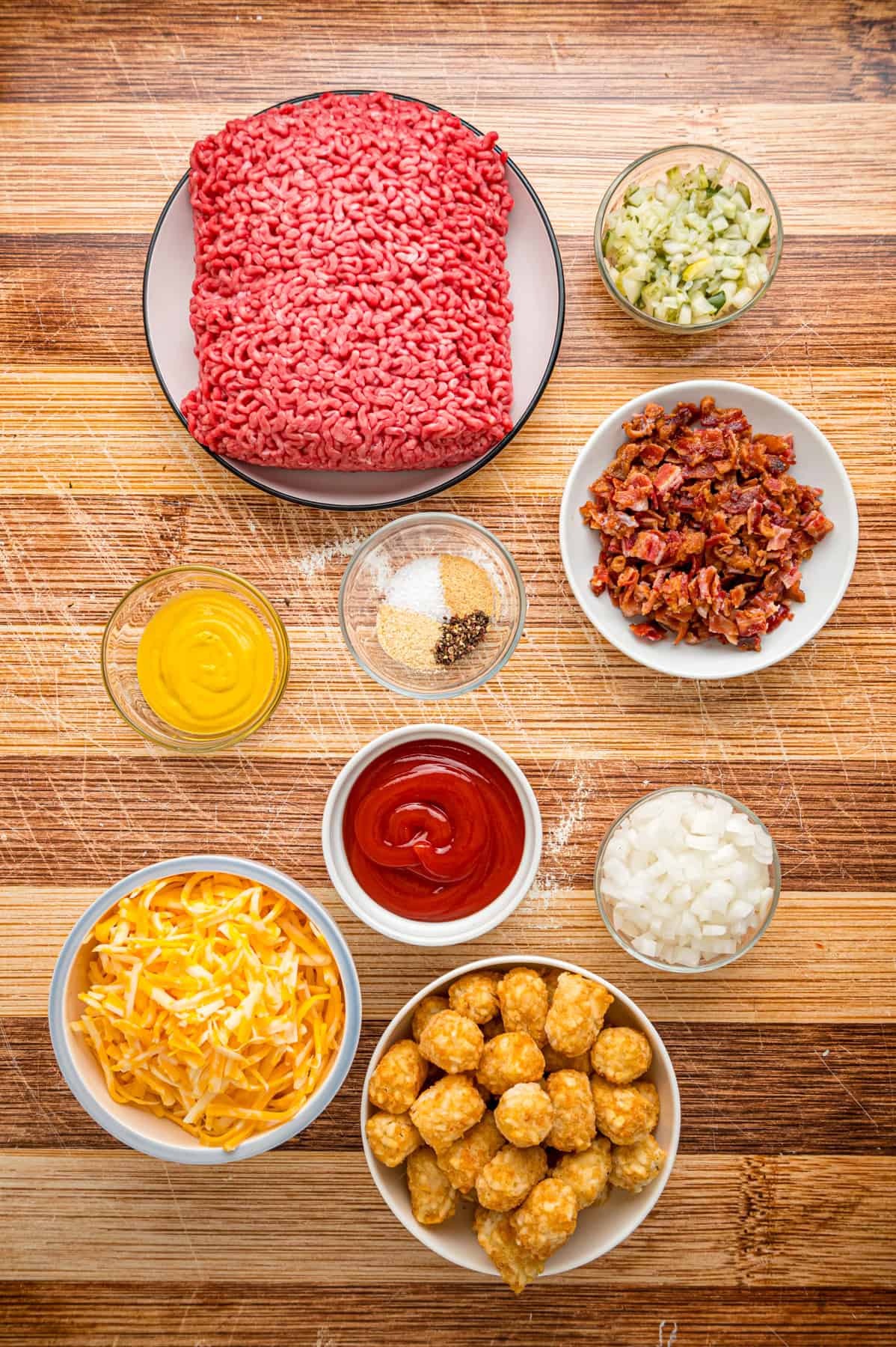 Overhead view of ingredients needed to make cheeseburger tater tot casserole