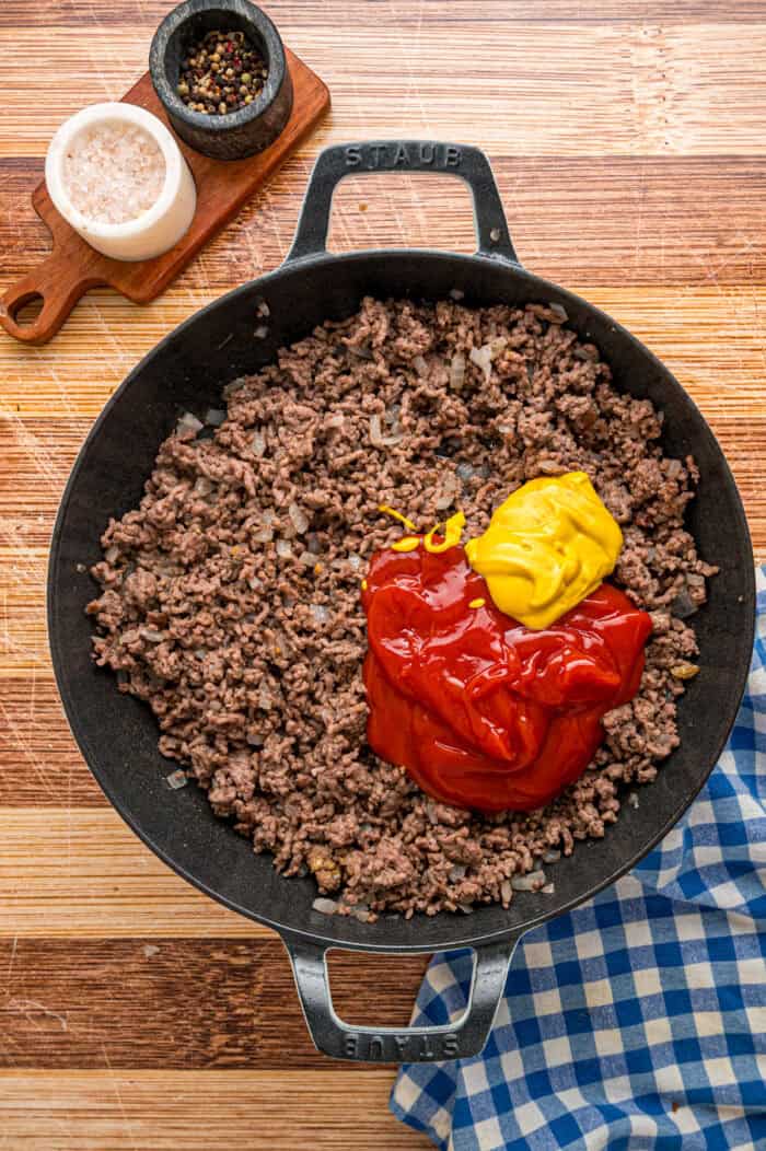Ketchup and mustard added to seasoned ground beef