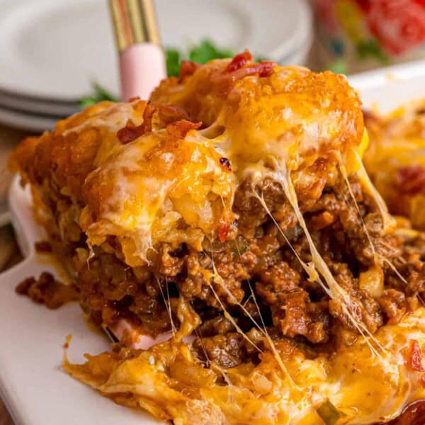 Serving a slice of cheeseburger tater tot casserole