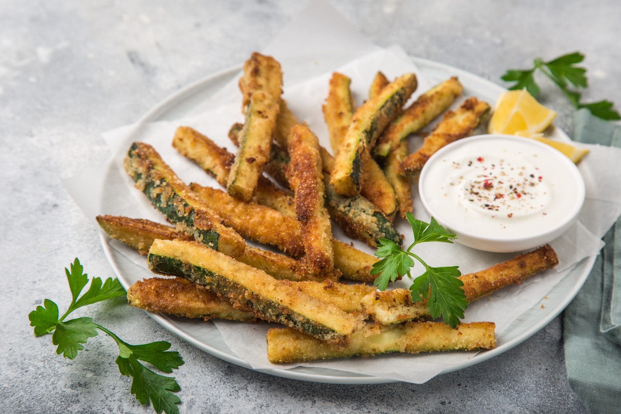 Crispy Baked Zucchini Fries on a plate with ranch dressing