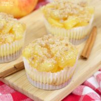 Apple Pie Cheesecake minis are a delicious combo of flaky apple pie and creamy cheesecake. This triple layered treat starts with a graham cracker crust and ends with a homemade crumble topping.
