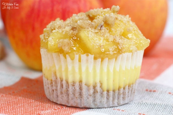 Apple Pie Cheesecake minis are a delicious combo of flaky apple pie and creamy cheesecake. This triple layered treat starts with a graham cracker crust and ends with a homemade crumble topping.
