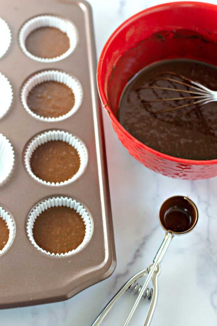 Cupcake liners filled with chocolate cupcake batter