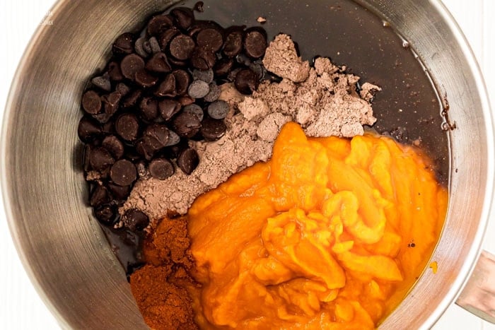 The ingredients for double chocolate pumpkin cookies combined in a mixing bowl.