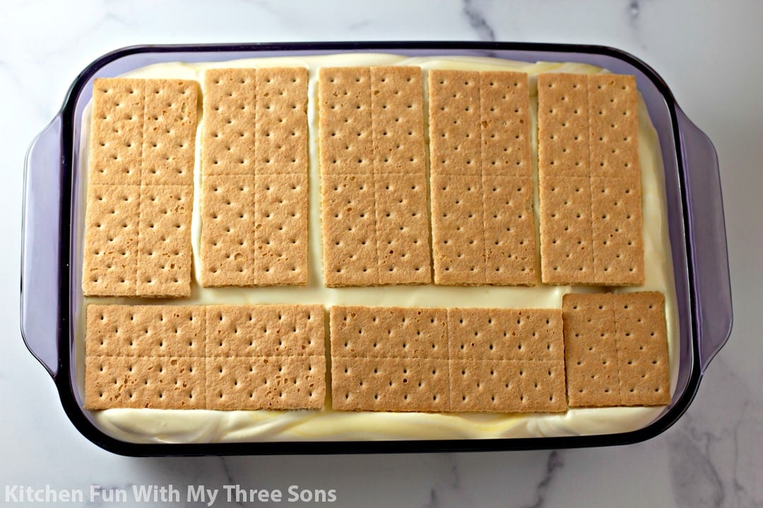 topping the cake with graham crackers