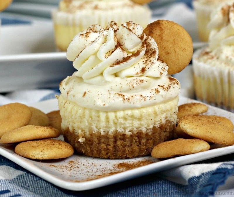 Mini cheesecakes with banana topping on a tray with Nilla wafers.