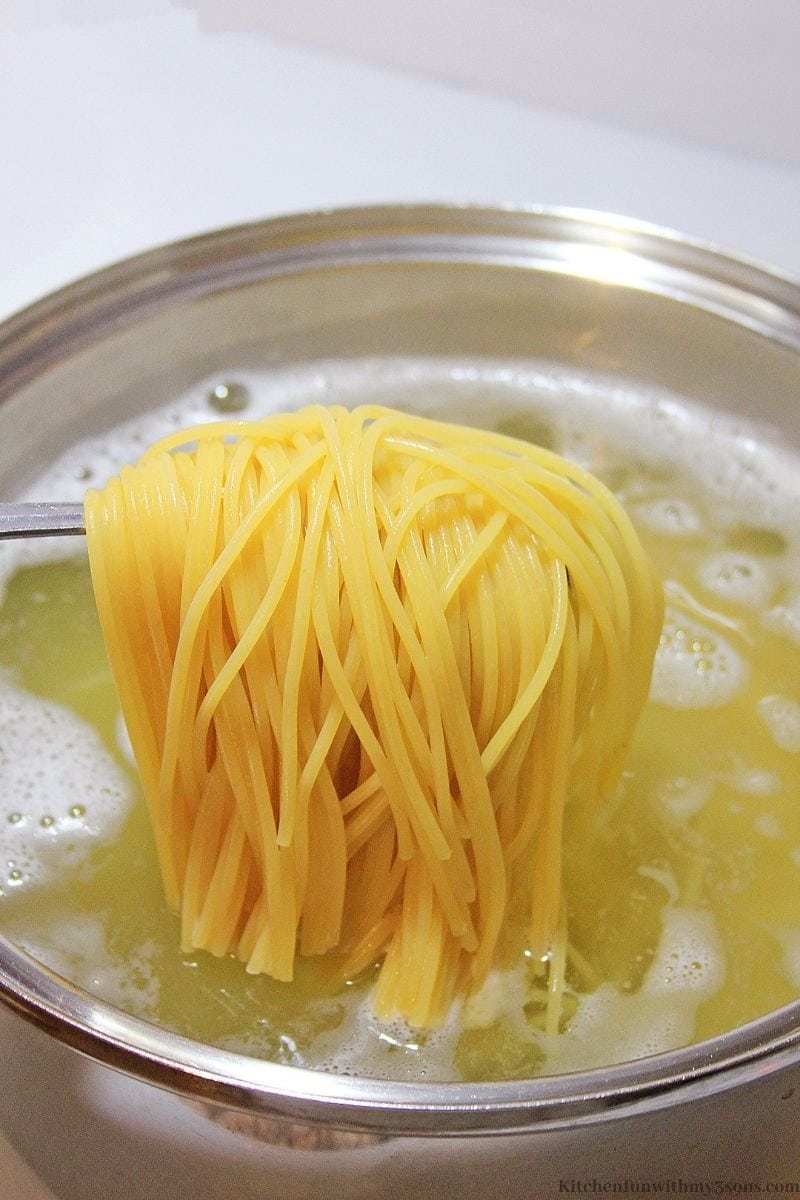 Preparing your choice of pasta by cooking in boiling water.