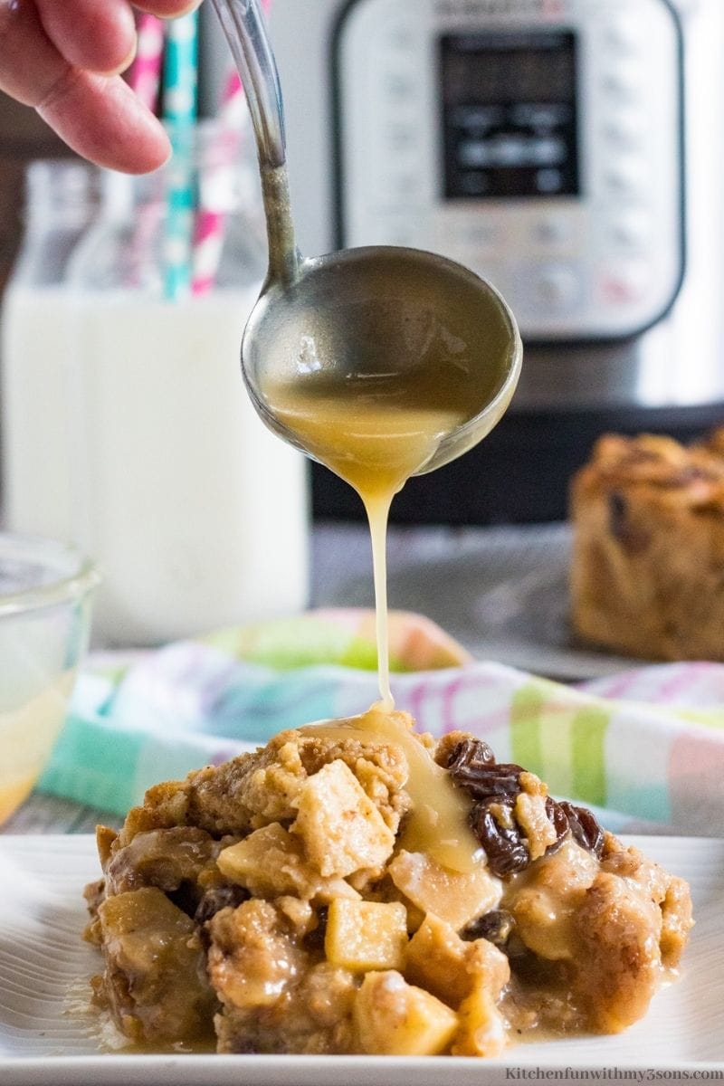 pouring rum sauce over the bread pudding