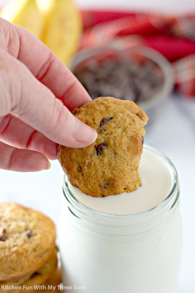 dipping Banana Chocolate Chip Cookies into a glass of milk