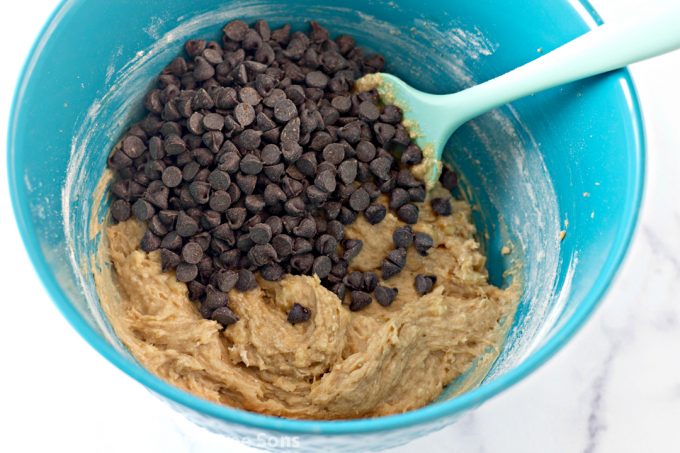 folding chocolate chips into cookie dough