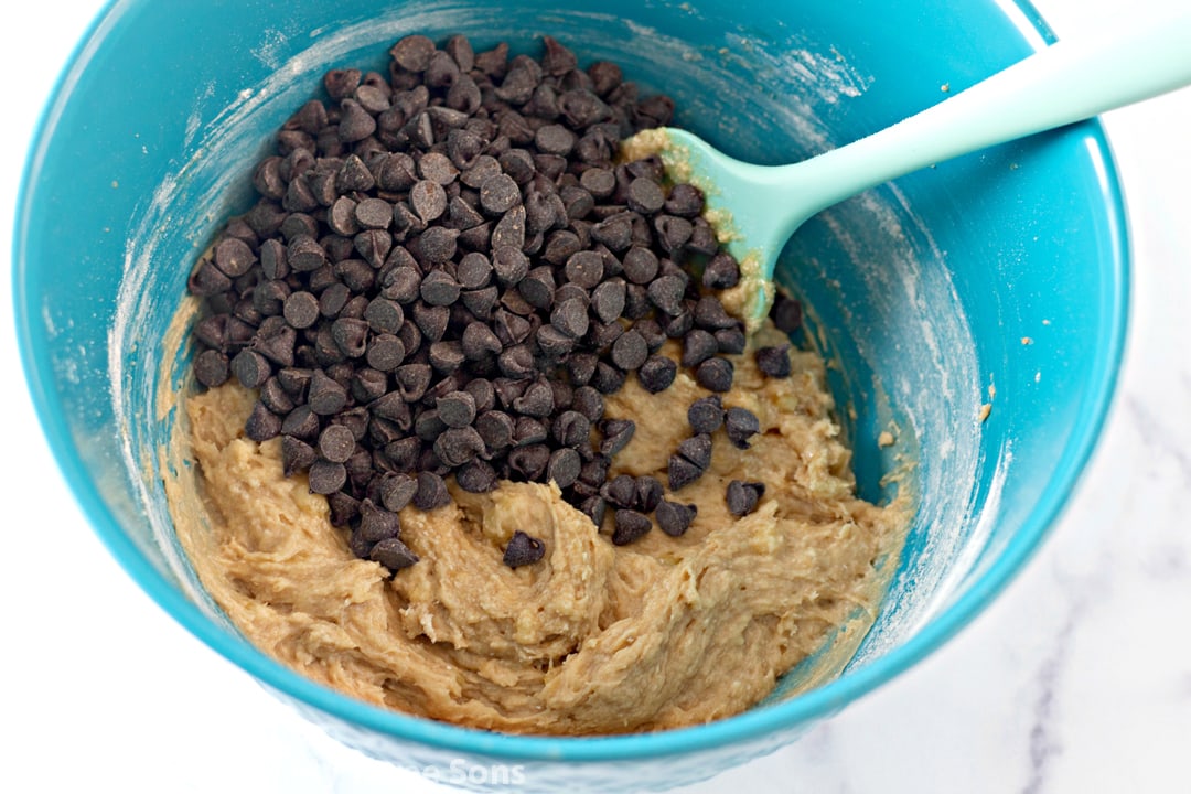 Banana chocolate chip cookie dough in a blue mixing bowl