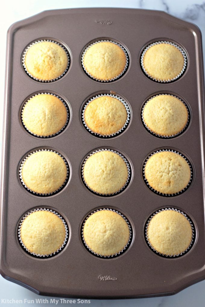 freshly baked vanilla cupcakes in a muffin pan