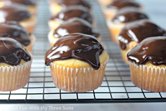 Boston Cream Cupcakes on a wire cooling rack