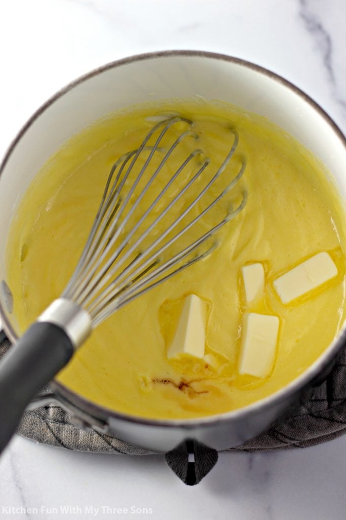 mixing the pastry cream in a sauce pan with butter and vanilla extract