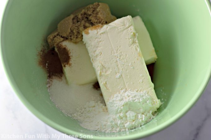 cheesecake ingredients in a mint green mixing bowl
