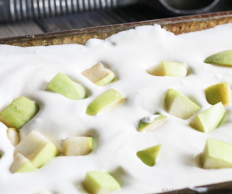 ice cream in a pan with apples on top