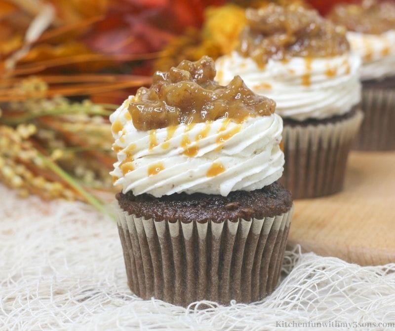 Chocolate Bourbon Pecan Pie Cupcakes on a netted white cloth.