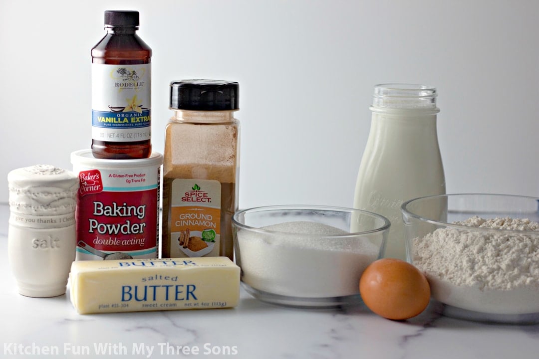 A stick of butter, an egg, baking powder, vanilla extract and the rest of the ingredients on a kitchen countertop