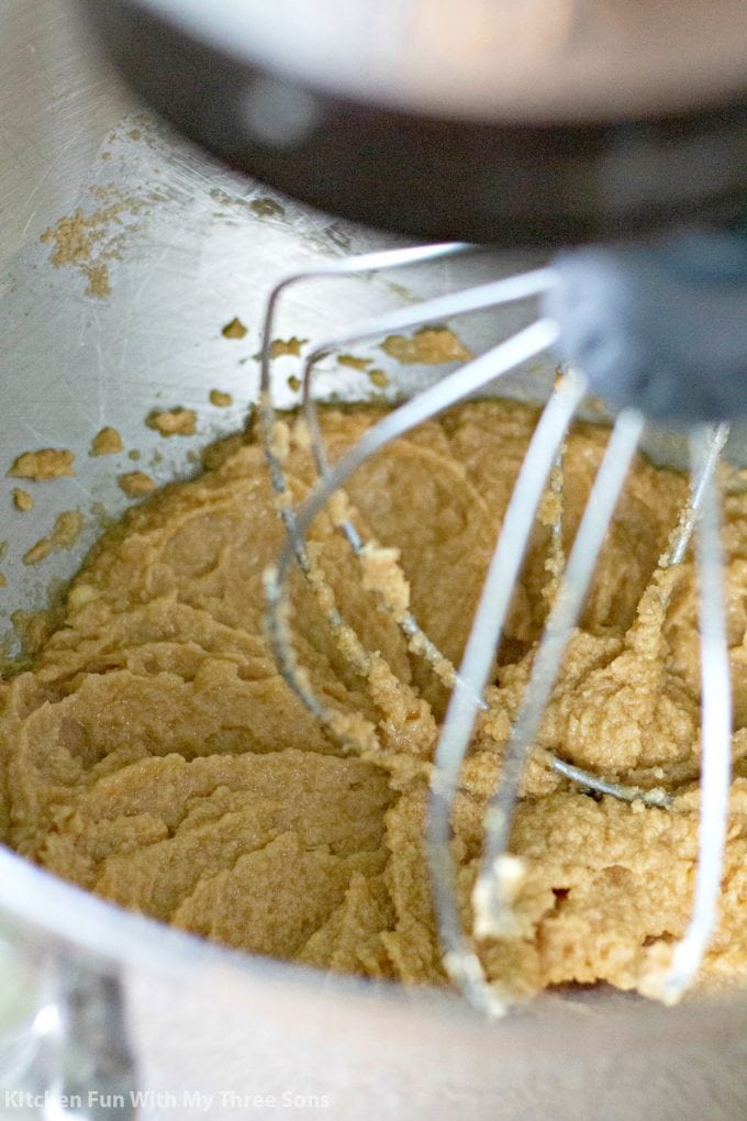beating together cookie ingredients in a stand mixer