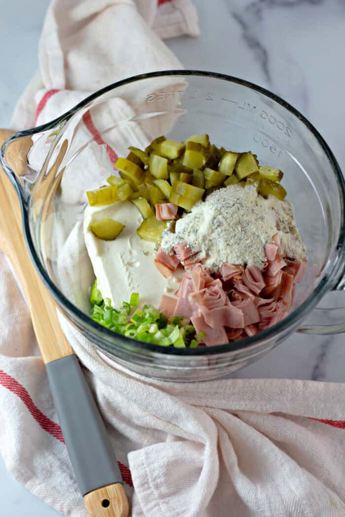 Cream cheese, diced pickles, ham, and ranch seasoning in a bowl