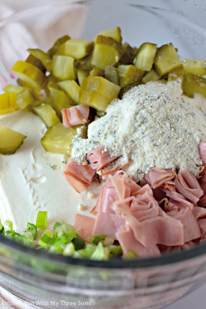 ham, cream cheese, ranch mix, pickles, and green onions in a clear batter bowl