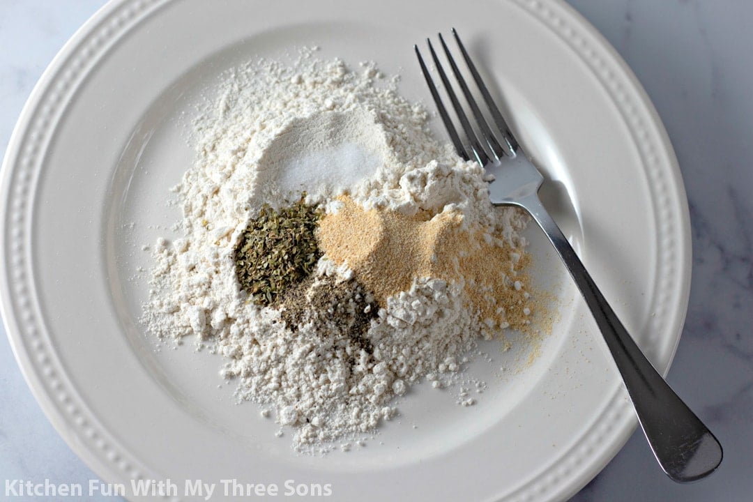 The dry batter ingredients, including the flour and spices, combined on a plate.