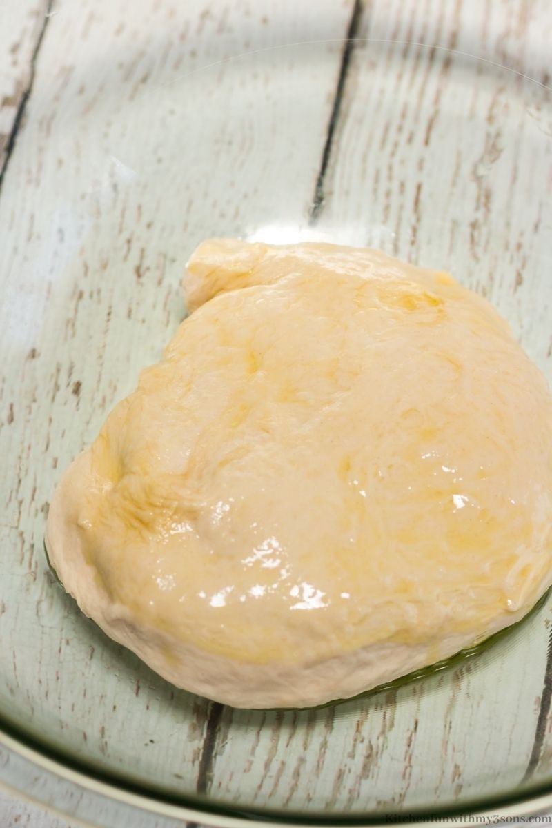 Dough coated in oil in a large bowl