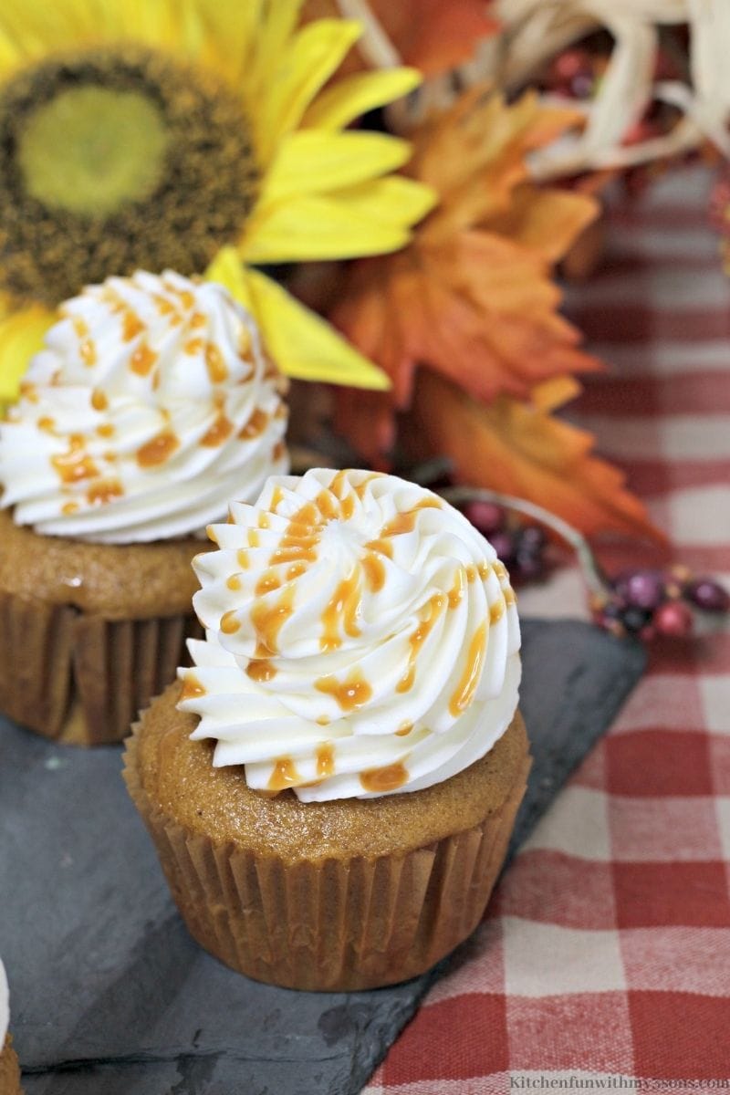 Pumpkin Salted Caramel Cupcakes on a red checkered tablecloth
