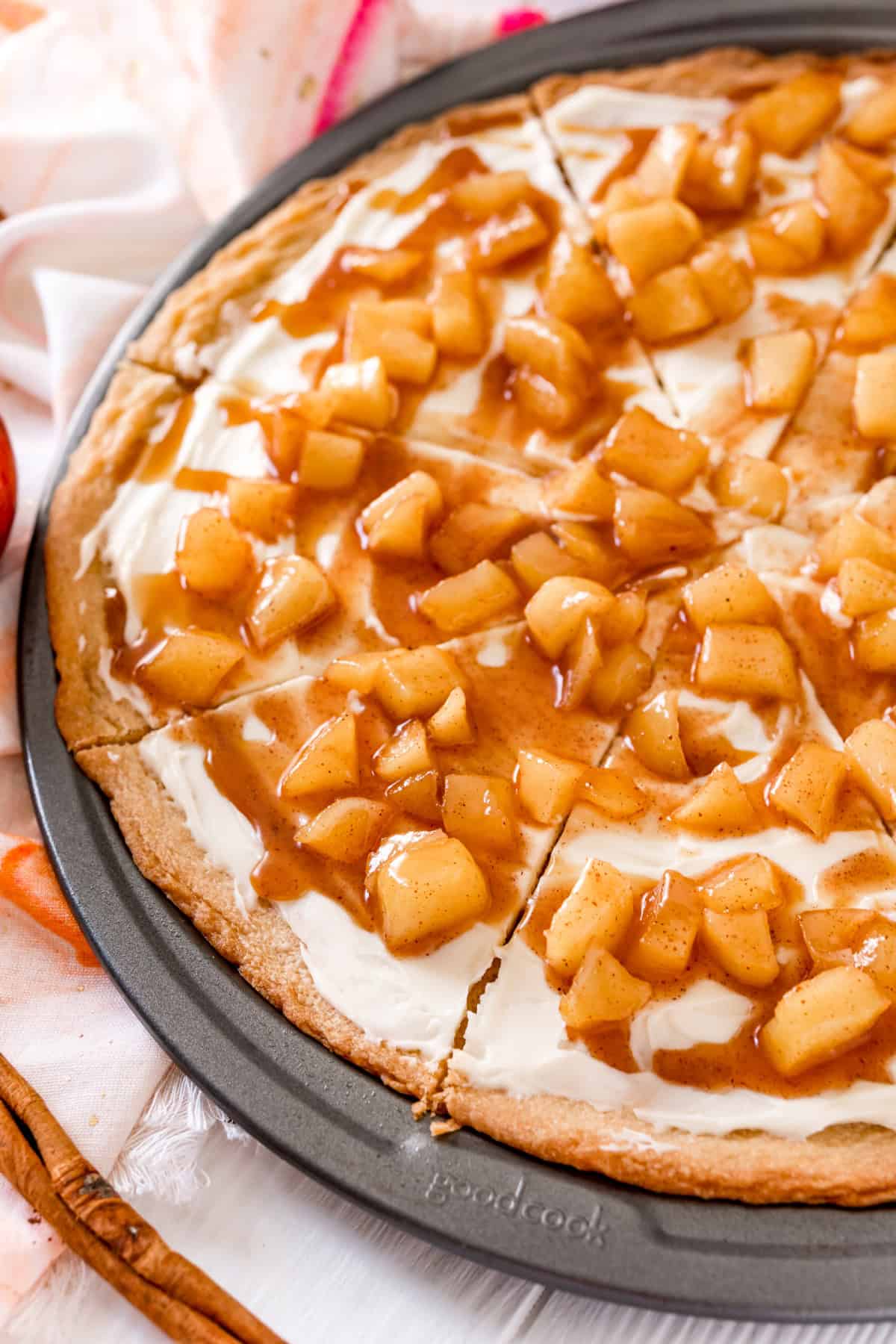 This Caramel Apple Dessert Pizza is always a huge hit for Fall. It starts with a sugar cookie crust then topped with layers of sweetened cream cheese and cinnamon caramel apples! Caramel Apple Dessert Pizza