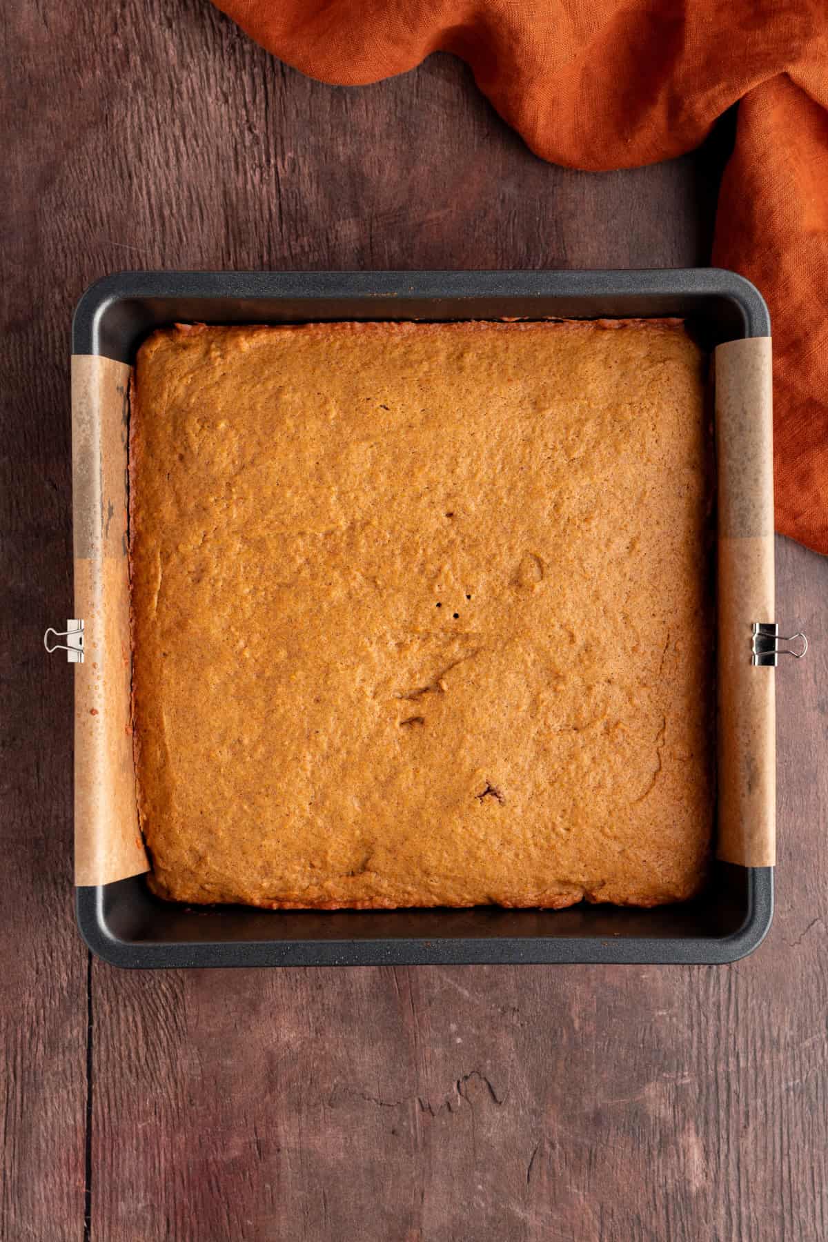 These Pumpkin Bars are soft, incredibly moist and loaded with warm spices. baked pumpkin bars in a pan