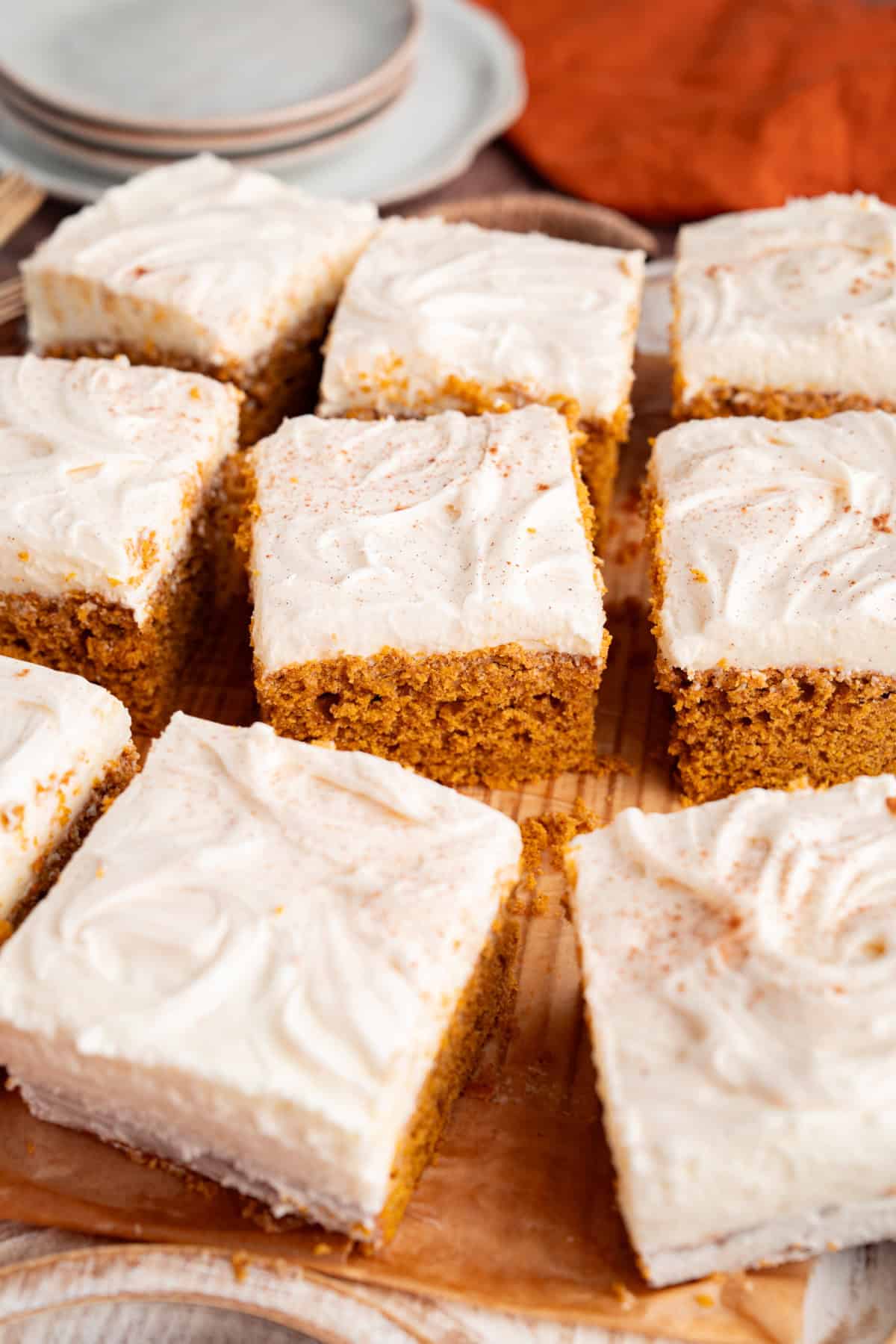 These Pumpkin Bars are soft, incredibly moist and loaded with warm spices. Pumpkin Bars with cream cheese frosting cut into squares.