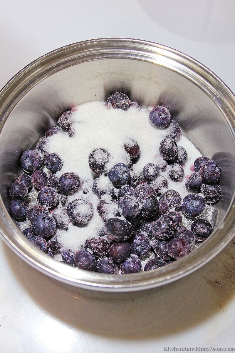 Cleaned berries in sugar in a pot.