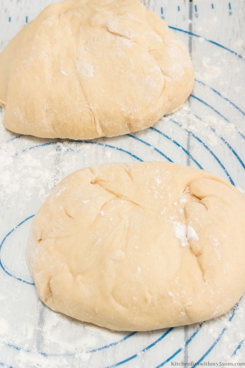 The bread dough cut in half.