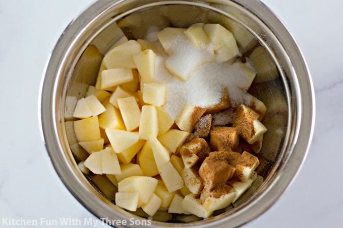 apples and cinnamon in a mixing bowl