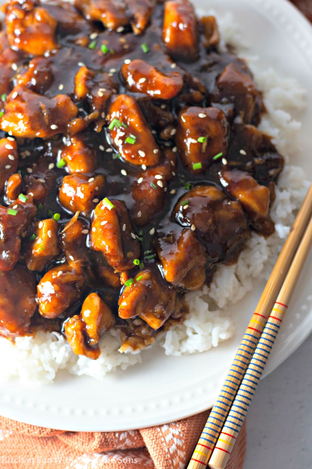 Bourbon Chicken over rice on a white plate