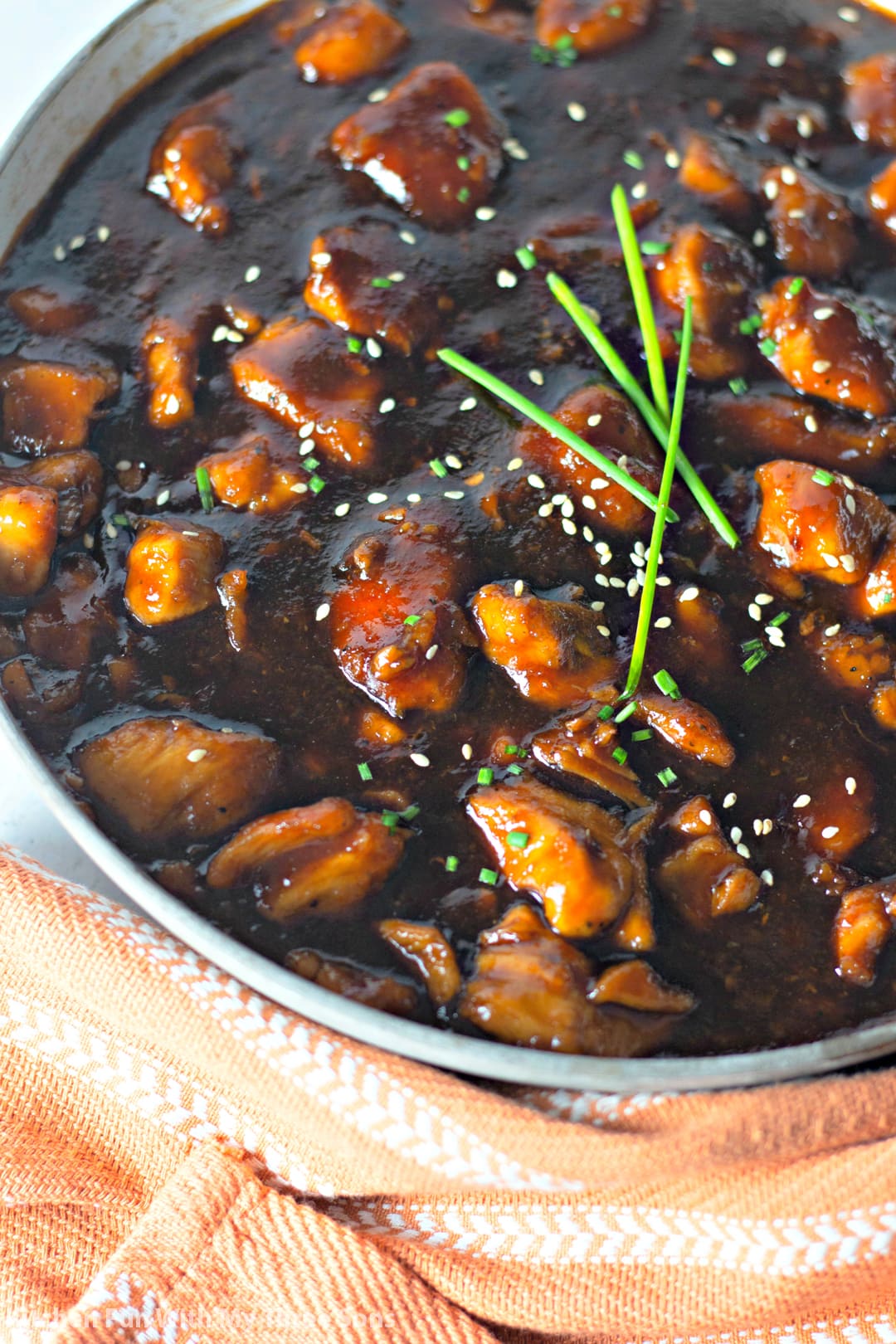 Bourbon Chicken in a bowl with a light brown towel