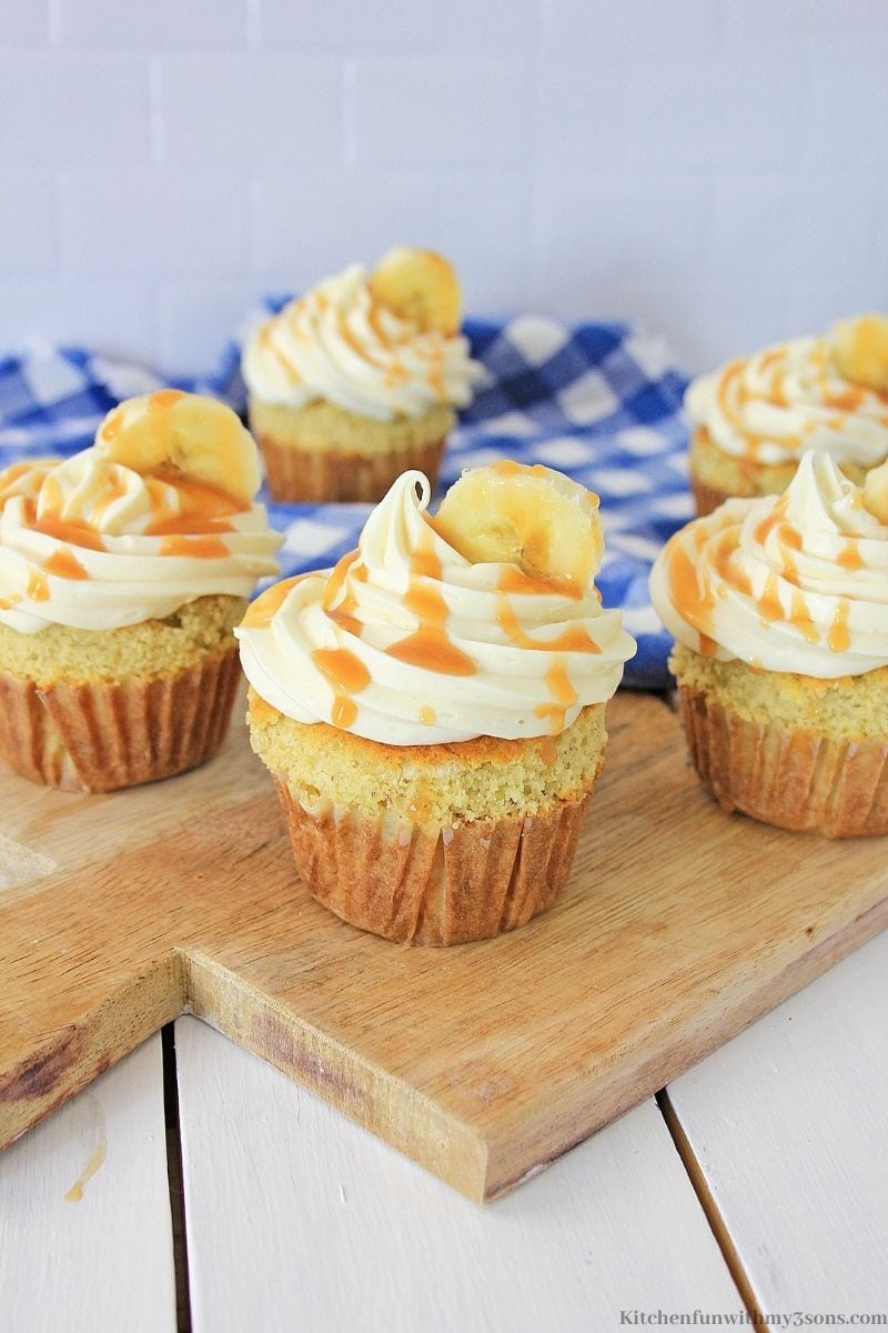 Delicious Banana Caramel Cupcakes on a wooded paddle.