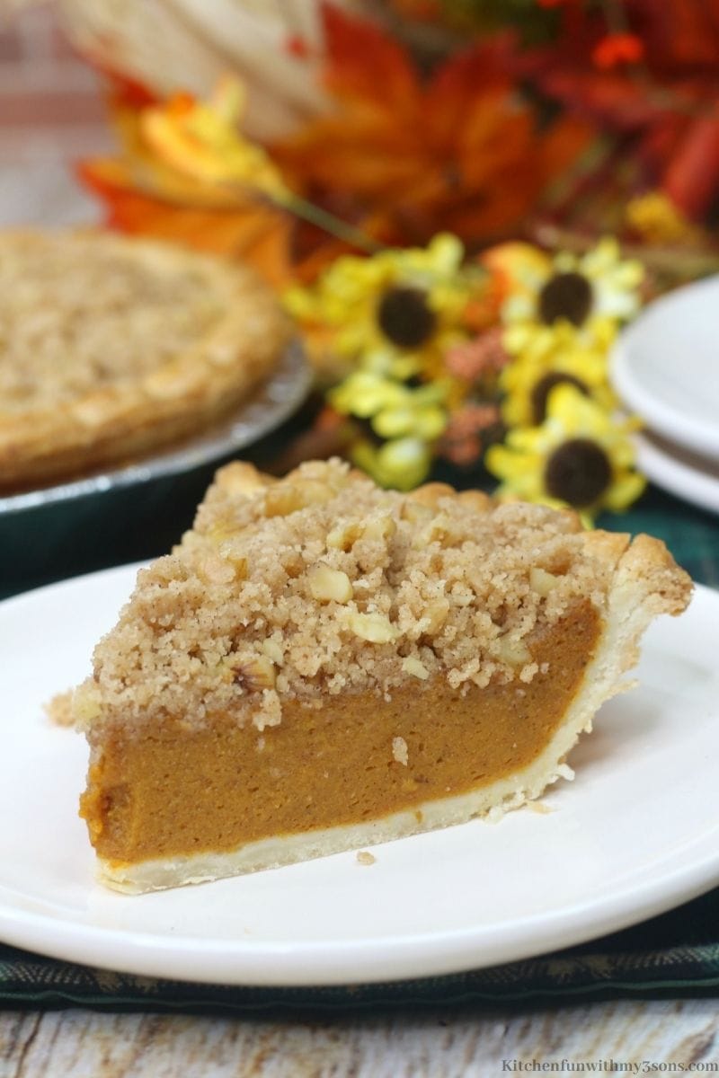 A close up of the Delicious Pumpkin Streusel Pie with the whole pie behind it.