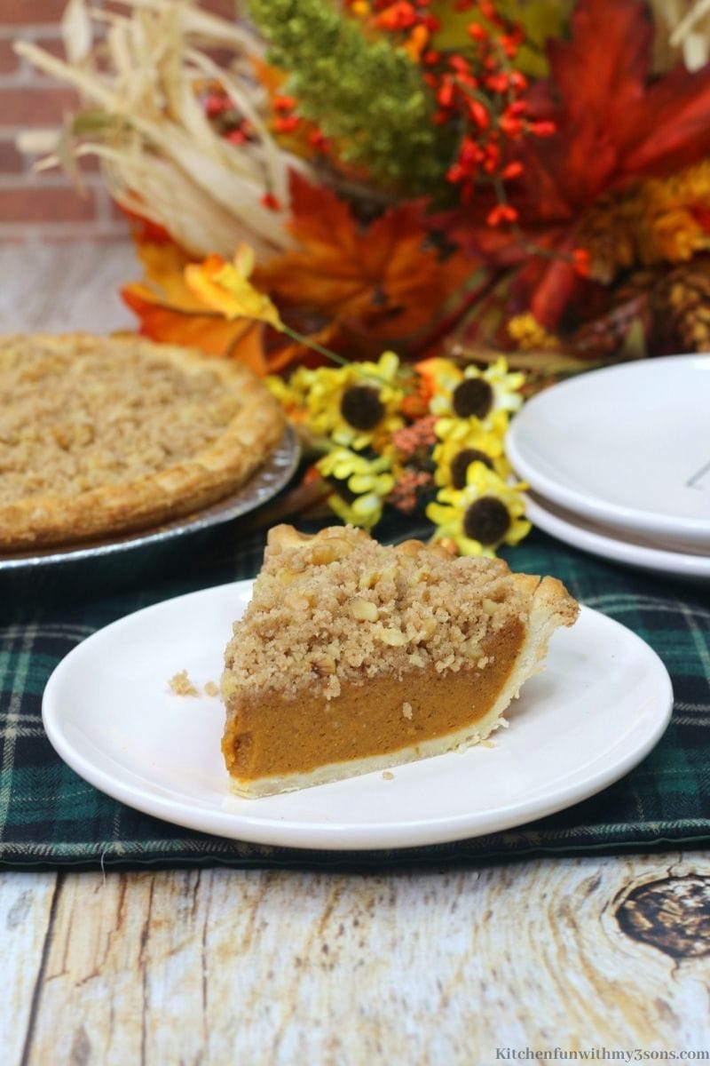 Delicious Pumpkin Streusel Pie on a plate on a patterned cloth.