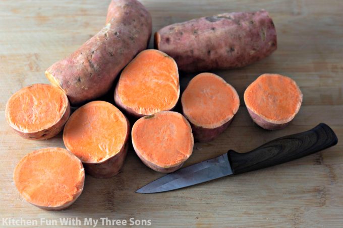 slicing sweet potatoes on a cutting board