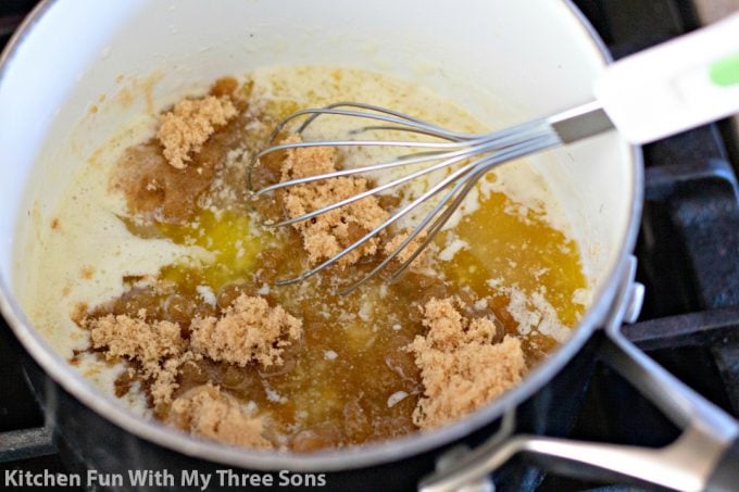mixing melted butter and brown sugar in a saucepan with a whisk