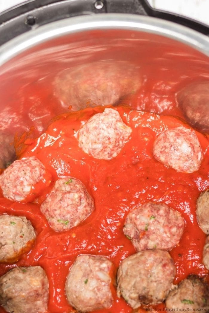 The sauce on top of the meatballs.