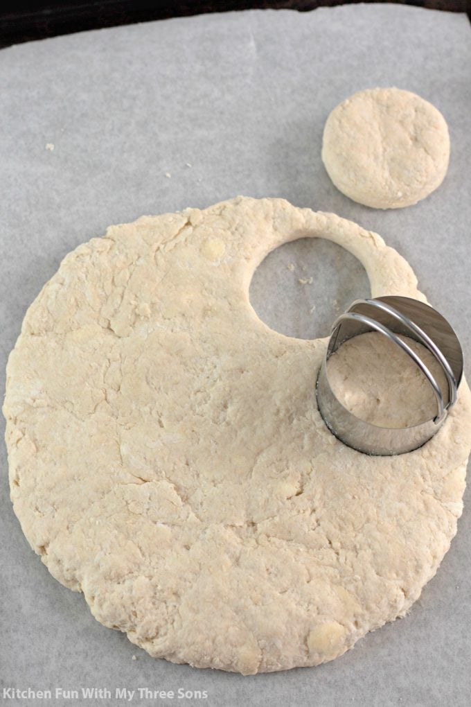 cutting biscuit dough with biscuit cutters