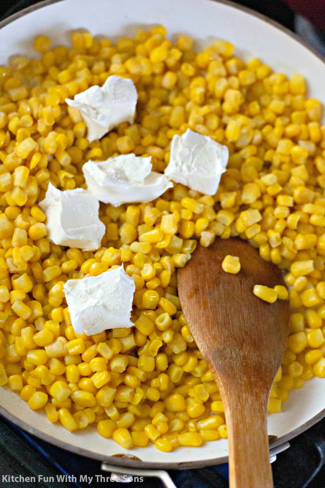 melting cream cheese into the corn