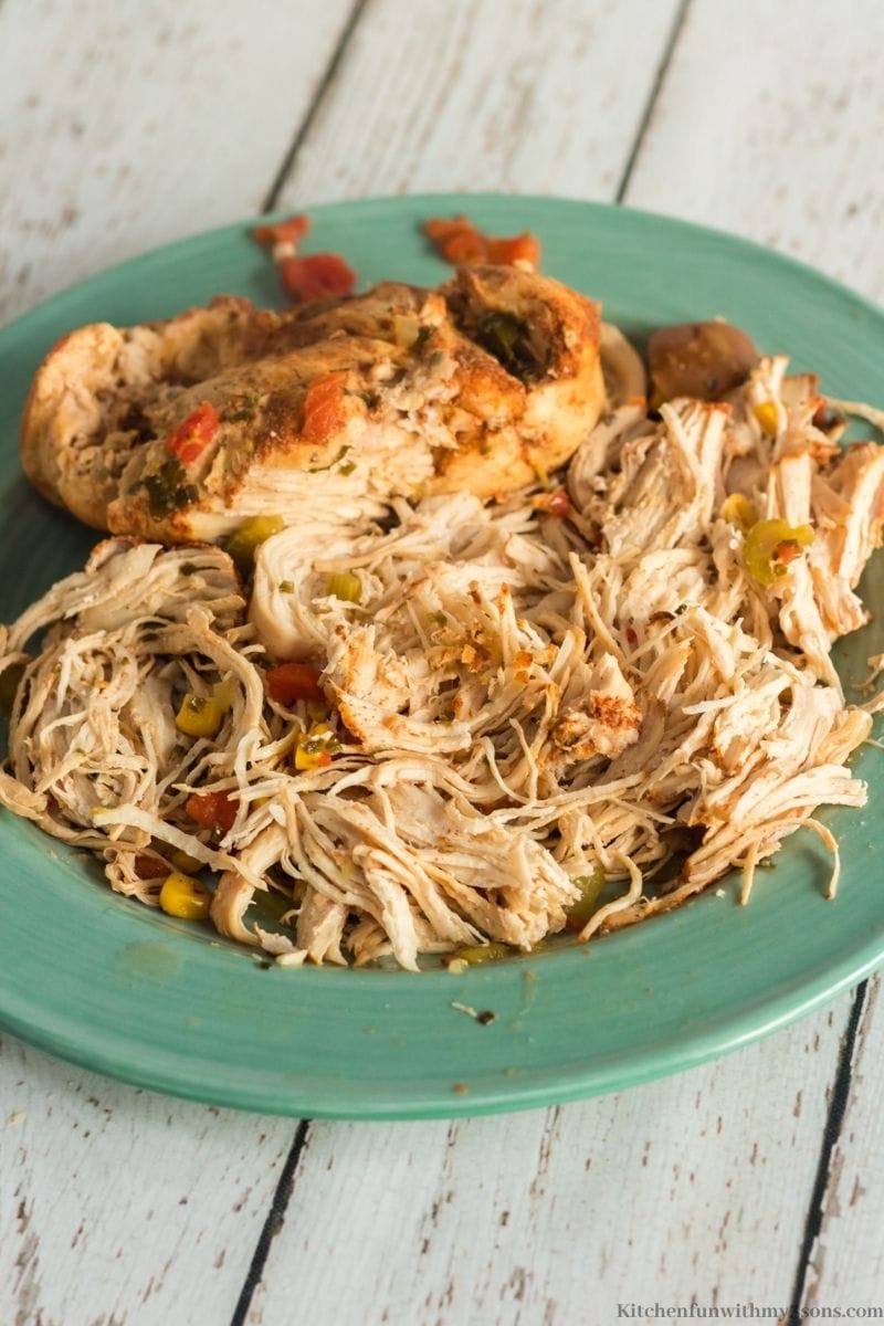 The chicken shredded on a plate.