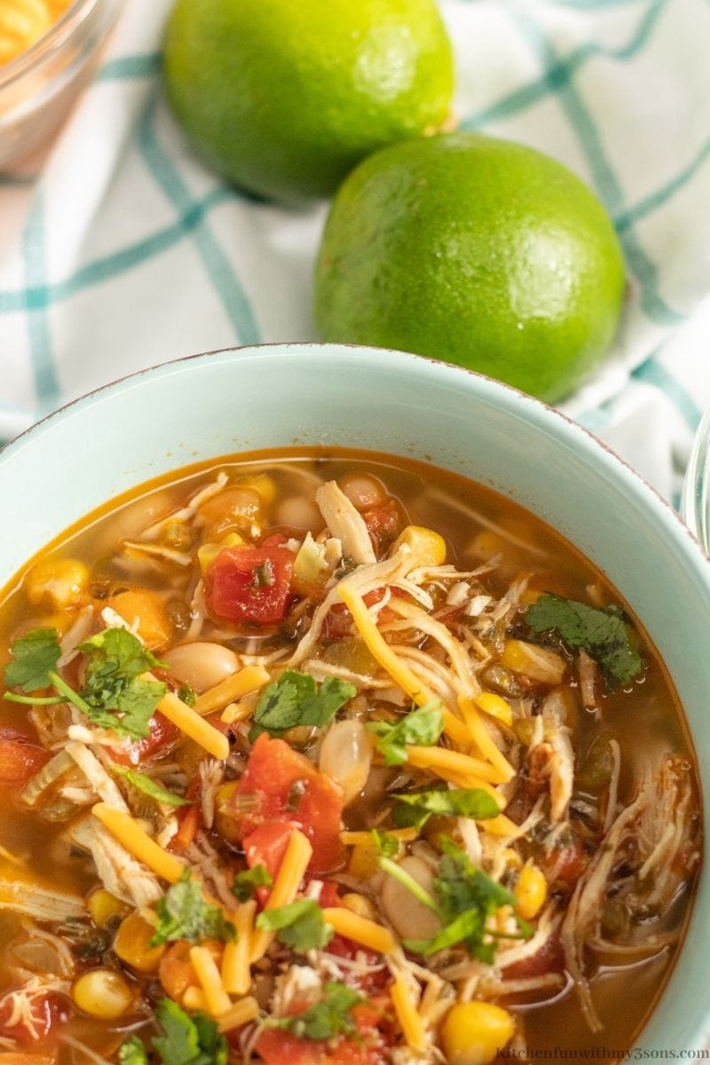 Instant Pot Chili Lime Chicken Soup Recipe with two lemons next to the serving bowl.
