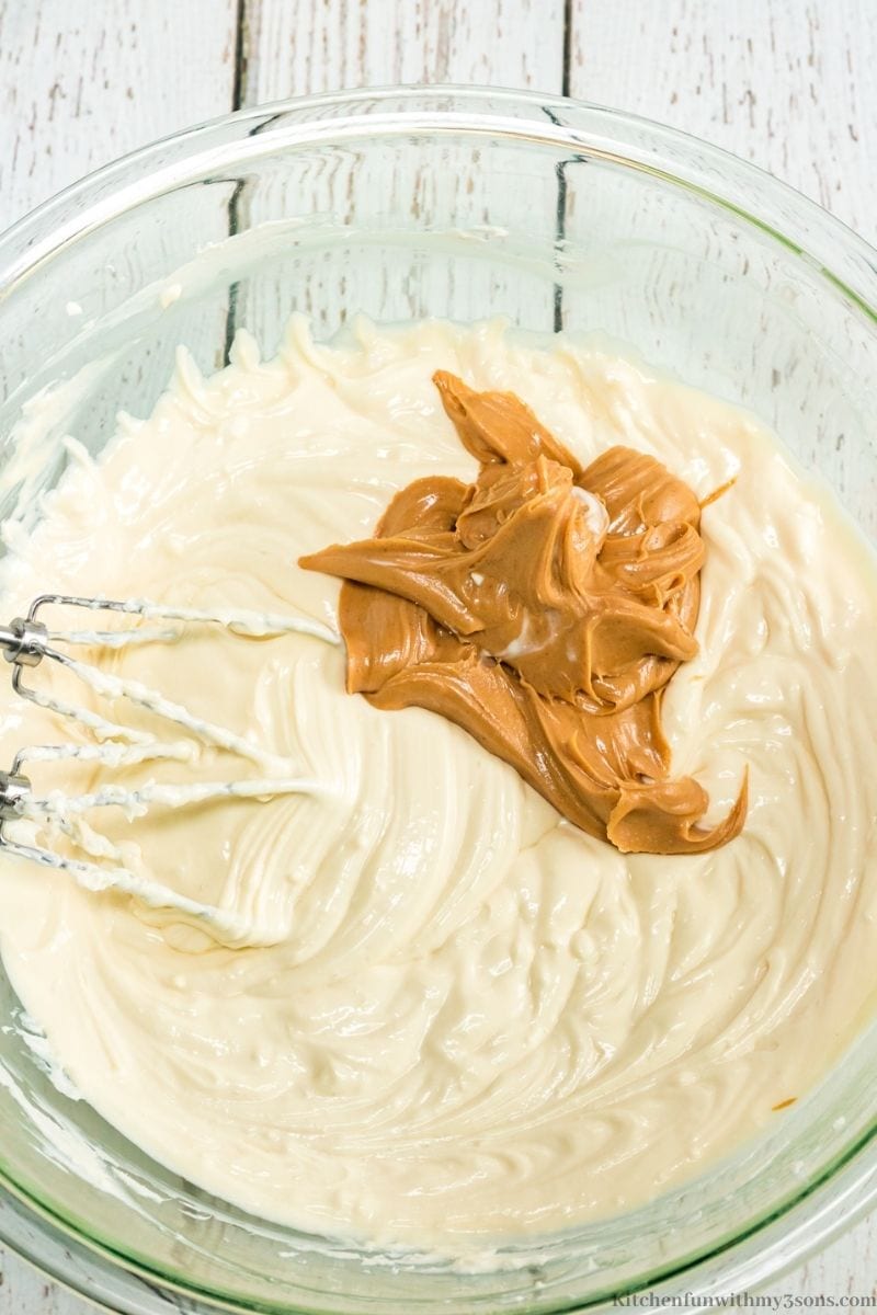 Adding the peanut butter into your cheesecake mixture.